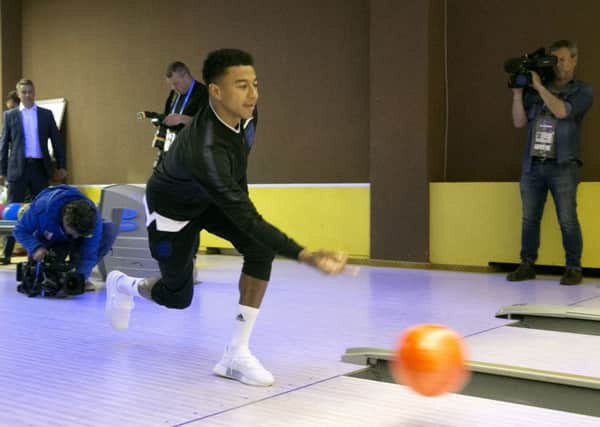 England's Jesse Lingard shows of his prowess at ten-pin at Repino Cronwell Park (Picture: Owen Humphreys/PA Wire).