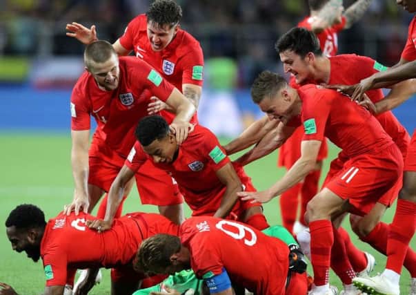 England's players dive on Jordan Pickford after Eric Dier's penalty secured a win over Colombia.