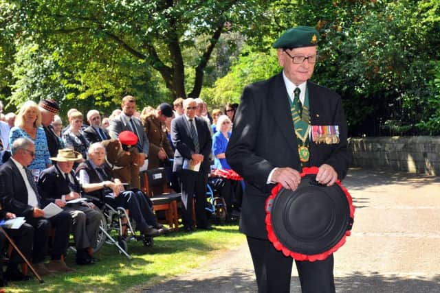 John Giddings a Kohima veteran walks  forward to the Kohima Memorial to lay  a wreath in the York Museum Gardens.