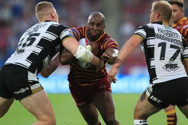 Huddersfield's Michael Lawrence is tackled by Hull's Chris Green and Danny Washbrook.