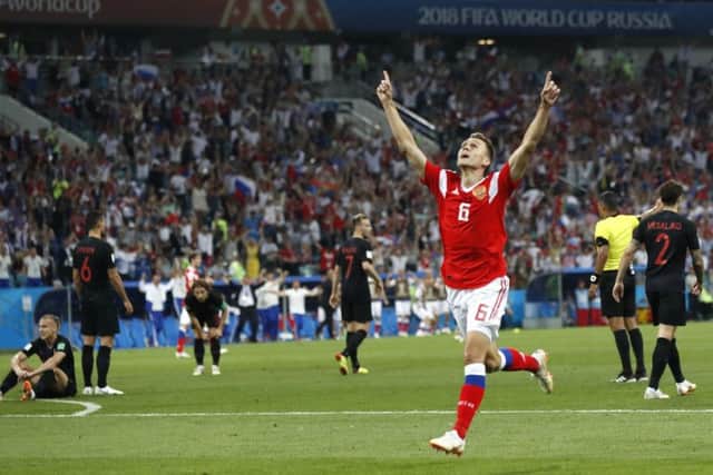 Russia's Denis Cheryshev celebrates after scoring his side's first goal during the quarter-final clash between Russia. Picture:  (APo/Pavel Golovkin