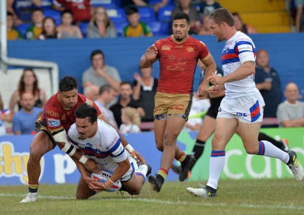 Justin Horo scores Wakefield's opening try against Catalans Dragons.
