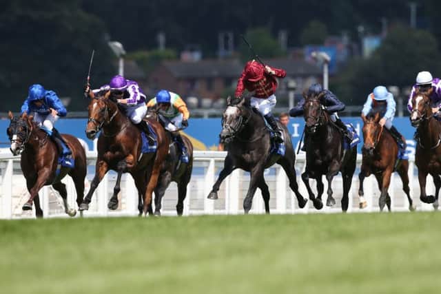 Roaring Lion ridden by Oisin Murphy (centre) challenge for the lead in the Eclipse.