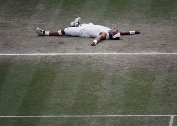 Spain's Rafael Nadal lies on the court as he celebrates his win over Switzerland's Roger Federer in the men's singles final on the Centre Court at Wimbledon, Sunday, July 6, 2008. (AP Photo/Filipe Trueba,pool)