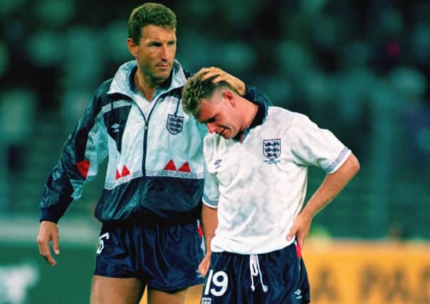 A tearful Paul Gascoigne (r) is consoled by team mate Terry Butcher after losing the FIFA World Cup 1990 semi-final to West Germany in a penalty shootout.  (Picture: David Cannon/Getty Images)