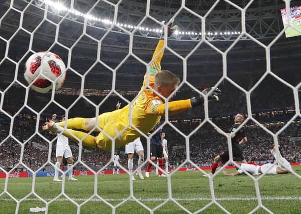 Croatia's Ivan Perisic scores his side's first goal past England goalkeeper Jordan Pickford. (AP Photo/Frank Augstein)