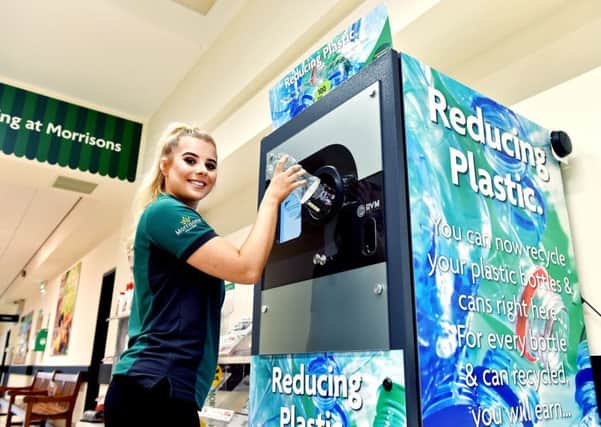 A woman uses a reverse vending machine for the return of single-use plastic bottles, which is being trialed at the supermarket chain to reduce their impact on the environment. PIC: PA