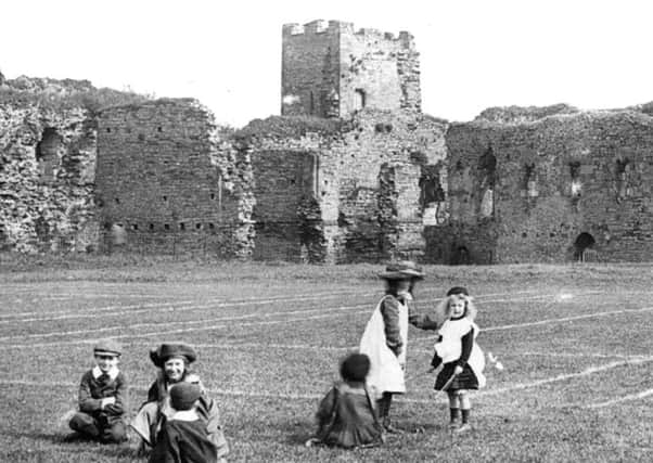 Children play in the grounds of Richmond Castle.