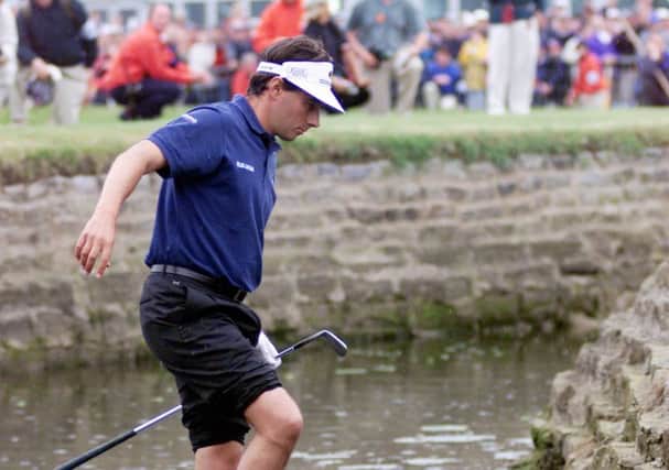 Spot of bother: Jean Van der Velde in the Barry Burn at Carnoustie in 1999 contemplating playing a shot out of the water.