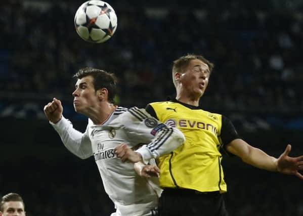 Real Madrid's Gareth Bale, left, and Borussia Dortmund's Erik Durm battle during a Champions League quarter-final. Picture: AP/Andres Kudacki