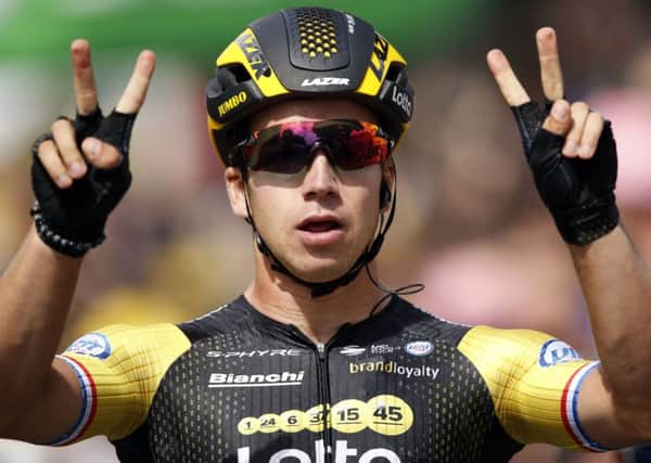 Netherlands' Dylan Groenewegen celebrates as he crosses the finish line to win the eighth stage of the Tour de Francein Amiens, France. (AP Photo/Christophe Ena )
