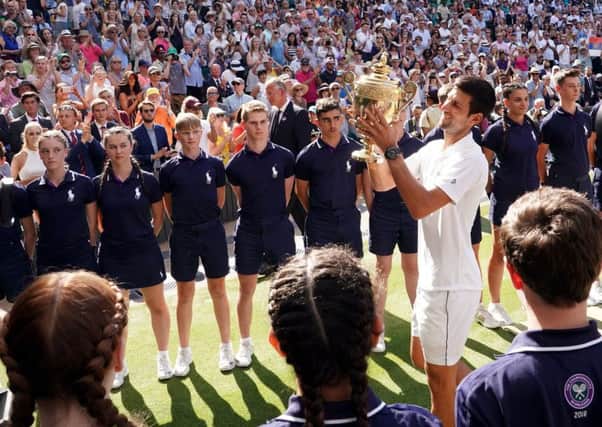 Novak Djokovic is given a guard of honour by the ballboys and ballgirls on Centre Court (Picture: John Walton/PA Wire).