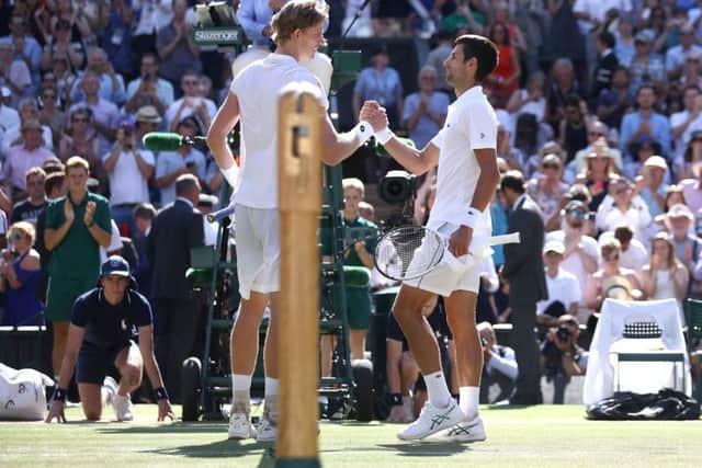 Novak Djokovic, right, is congratulated by Kevin Anderson after the men's singles final (Picture: John Walton/PA Wire).