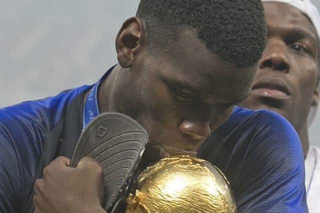 France's Paul Pogba celebrates with the trophy.