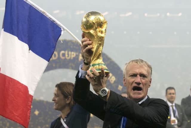 France head coach Didier Deschamps poses with the World Cup trophy. Picture: Owen Humphreys/PA