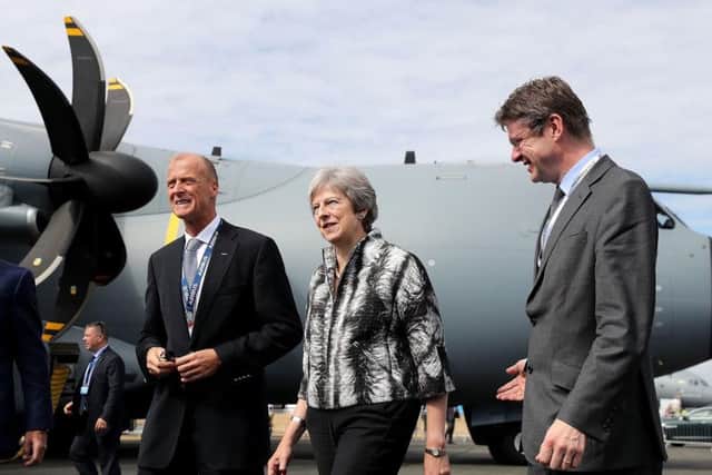 British Prime Minister Theresa May talks with Airbus CEO Tom Enders (left) as she officially opened the Farnborough International Airshow in Hampshire. PA