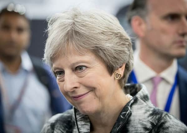 Theresa May put on a brave face as she opened the Farnborough International Airshow.