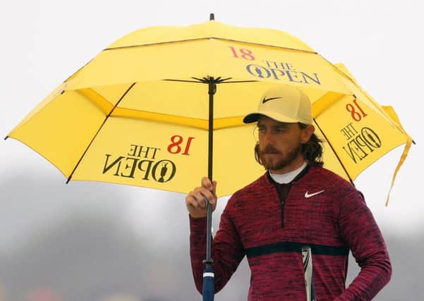 Tommy Fleetwood walks the fairways of Carnoustie during his flawless six-under-par 65 yesterday carrying an Open Championship umbrella that was given to him (Picture: David Davies/PA Wire).