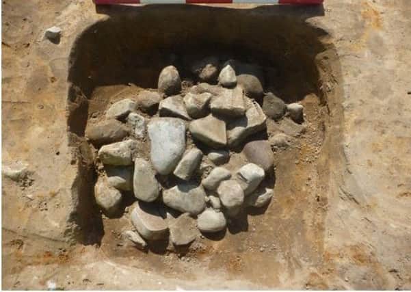 The hearth with burnt cobbles in situ, at the centre of the ring gully. Picture: York Archaeological Trust