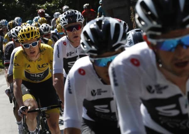 Team Sky with Britain's Geraint Thomas, wearing the overall leader's yellow jersey, and Britain's Chris Froome, to his right, sets the pace for the pack during the fifteenth stage of the Tour de France. Picture: AP/Christophe Ena