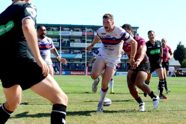 James Batchelor is ecstatic after running in a try for Wakefield Trinity at the end of the first half against Hull FC (Picture: James Hardisty).