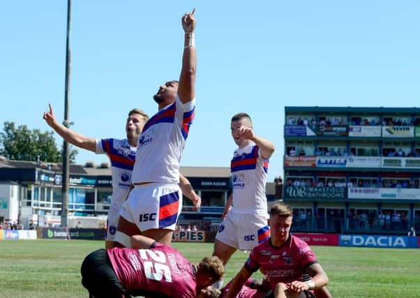 Wakefield Trinity's Pauli Pauli points to the sky after scoring one of his side's 12 tries against Hull FC (Picture: James Hardisty).