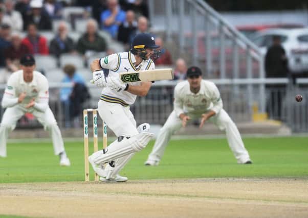 Yorkshire's Adam Lyth cuts through the covers on day one at Old Trafford against Lancashire. Picture: Steve Riding.