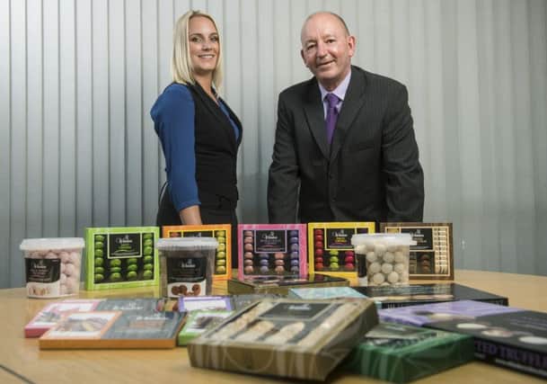 SWEETENING EXPORTS: Chamber International export adviser, Hayley Bates
and Whitakers Chocolates sales manager, Ian Webster, at the companys base in
Skipton.