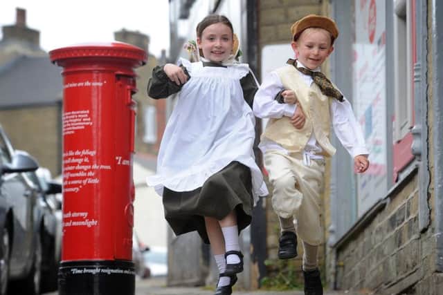 New Royal Post Office box is dedicated to Emily Bronte, Market Street, Thornton. Mary Border and Ethan Bell from Thornton Primary School are pictured by the new post box.