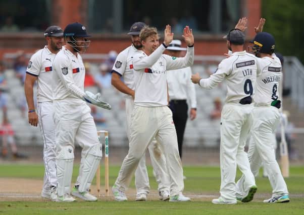 Spinning in:  Joe Root celebrates with Adam Lyth after they combined to take the wicket of Matt Parkinson. Picture: Alex Livesey/Getty Images