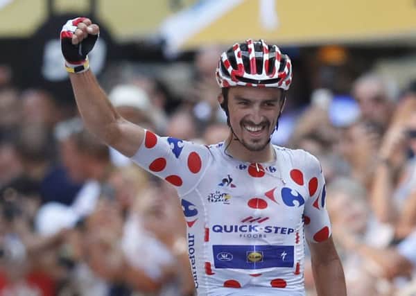 France's Julian Alaphilippe celebrates as he crosses the finish line to win the 16th stage of the Tour de France (Picture: Christophe Ena/AP).