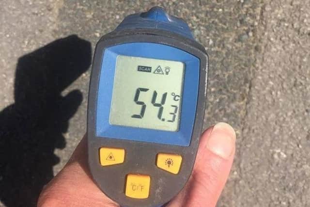 The thermometer reading shows just how hot the ground is
