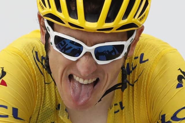 Britain's Geraint Thomas, wearing the overall leader's yellow jersey, grimaces as he crosses the finish line of the seventeenth stage of the Tour de France. (Picture: AP Photo/Peter Dejong)