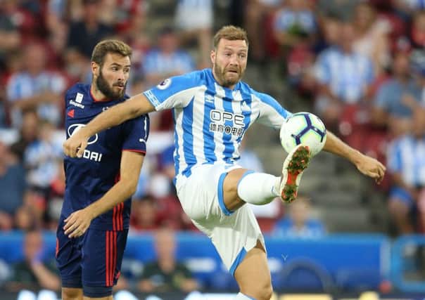 Huddersfield Town's Laurent Depoitre (right) and Lyon's Lucas Tousart battle for the ball during a pre-season friendly match at the Kirklees Stadium, Huddersfield. (Picture: PA)