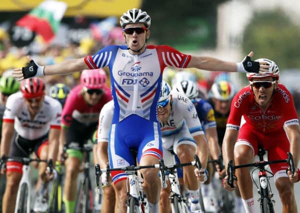 France's Arnaud Demare celebrates as he crosses the finish line to win the 18th stage of the Tour de France (Picture: Christophe Ena/AP).