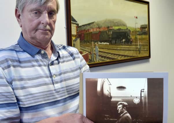 Ralph Bartle with a picture of his brother Peter at DLA Piper. Rotherham signalman Peter Bartle was a self-taught artist as well as working on the trains.