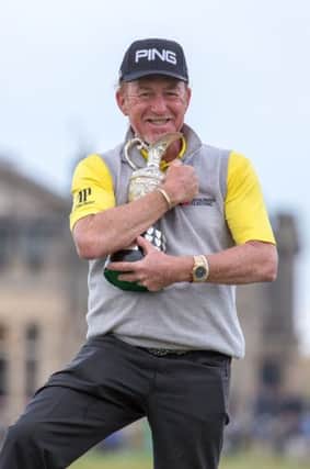 Spain's Miguel Angel Jimenez celebrates with the trophy after winning the Senior Open at Old Course St Andrews.