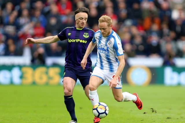 Huddersfield Town's Alex Pritchard (right) competing with Leighton Baines of Everton last year is relishing a first pre-season under David Wagner (Picture: PA)
