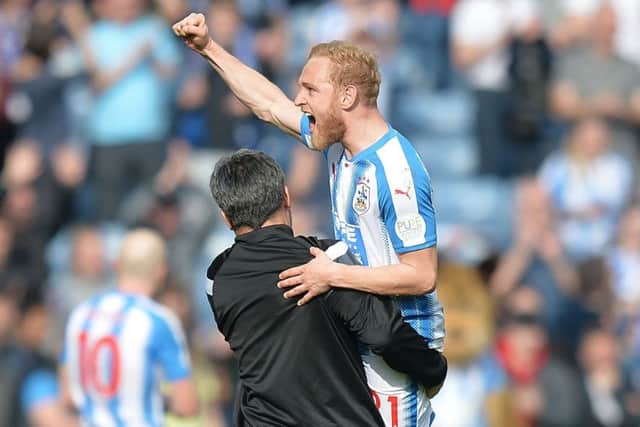 Huddersfield Town's Alex Pritchard celebrates a victory last season with manager David Wagner