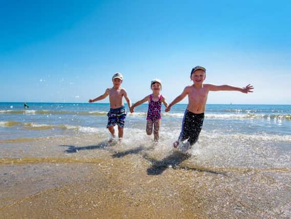 Pictured cooling down in the Bridlington sea (left to right) Dillan Bielby, 6, Millie Bielby, 4, and Ryan Dixon, 6.