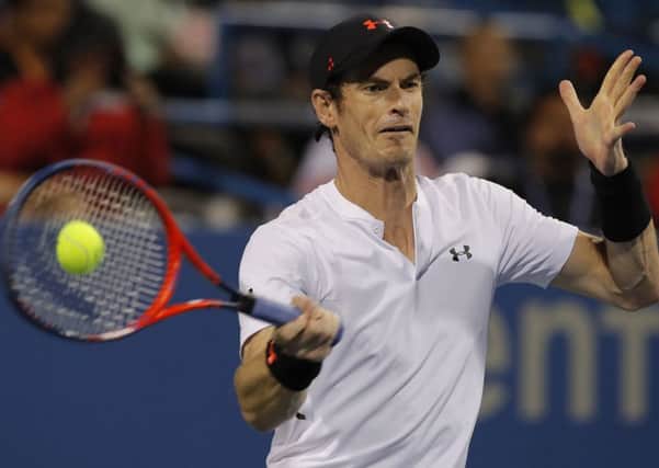 On his way to victory: Andy Murray returns against Mackenzie McDonald.