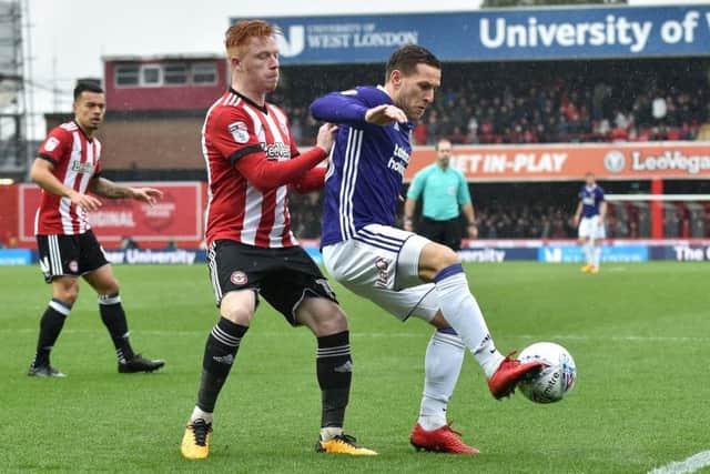 Wanted by Leeds: Ryan Woods of Brentford, holding up Billy Sharp.