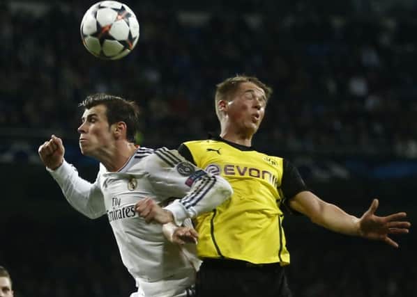 In line for Town: Real's Gareth Bale, left, being challenged by Dortmund's Erik Durm, who is set for Huddersfield debut.