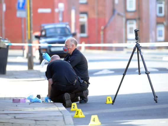 Forensic officers at the scene in Hyde Park, Leeds. Picture: Simon Hulme.