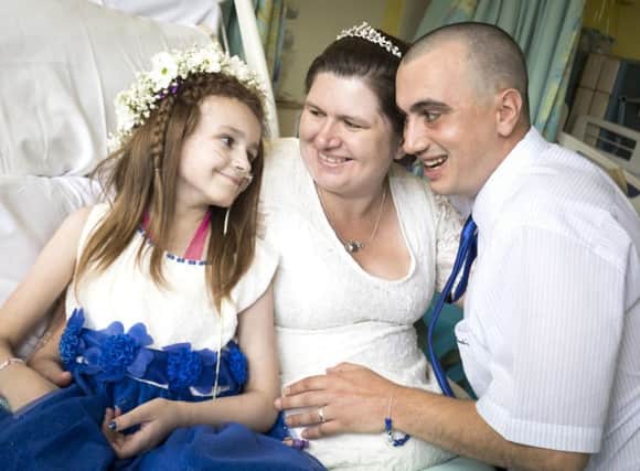Cancer patient Kayleigh Walsh with her parents Lyndsey and Paul Walsh, following their wedding blessing ceremony at Sheffield Children's Hospital.