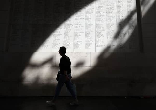 Sunlight casts a shadow across some of the names of the Passchendaele fallen carved into the Menin Gate in Ypres.