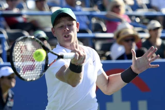 Kyle Edmund, of Britain, returns a shot to Andy Murray, of Britain, during the Citi Open tennis tournament Wednesday. (AP Photo/Nick Wass)