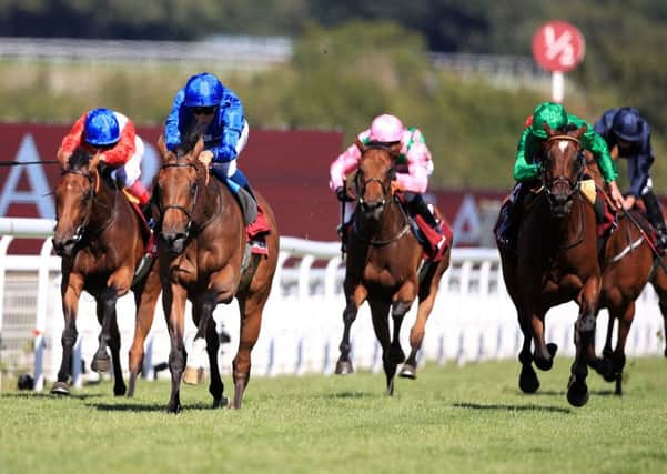 Wild Illusion ridden by jockey William Buick (2nd left) comes home to win the Qatar Nassau Stakes during day three of the Qatar Goodwood Festival.