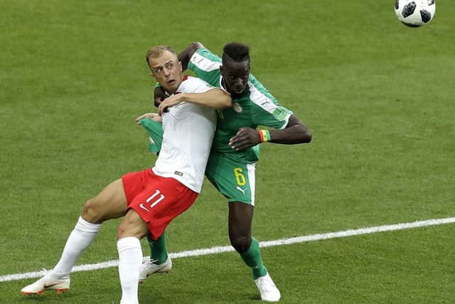 On his way from Tigers?: Poland's Kamil Grosicki, left, and Senegal's Salif Sane fight for possession at the World Cup.