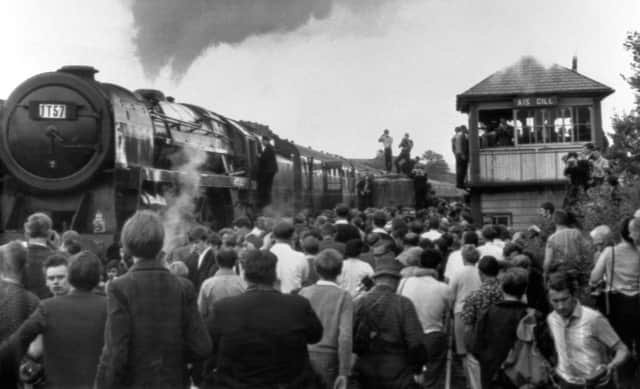 Thousands of people straining to get a look at Britain's last mainline steam passenger train as it passed through Rainhill station, between Liverpool and Manchester, in 1968